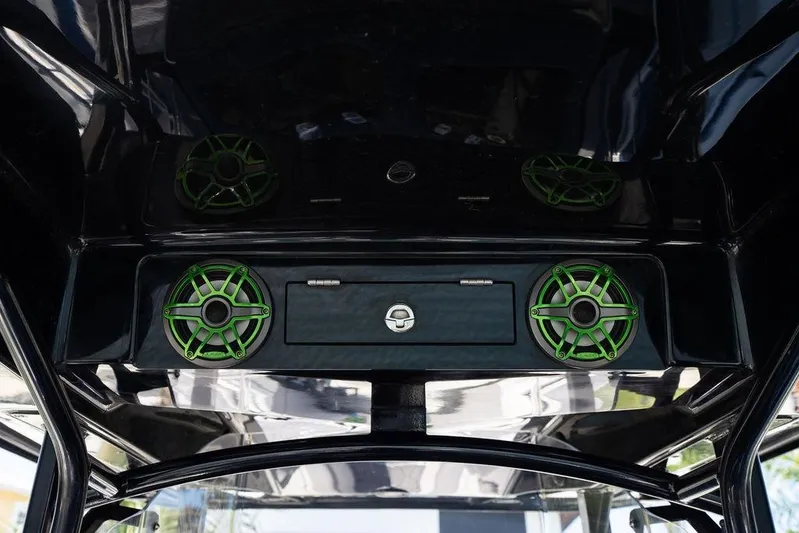  Yacht Photos Pics 2022 Fountain 34 SC boat with green speakers and sleek black interior design.