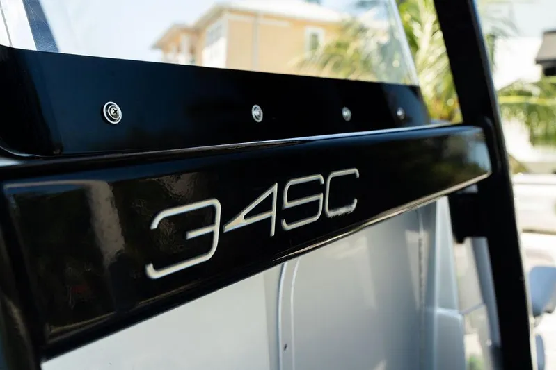  Yacht Photos Pics 2022 Fountain 34 SC boat model emblem with sleek black design.