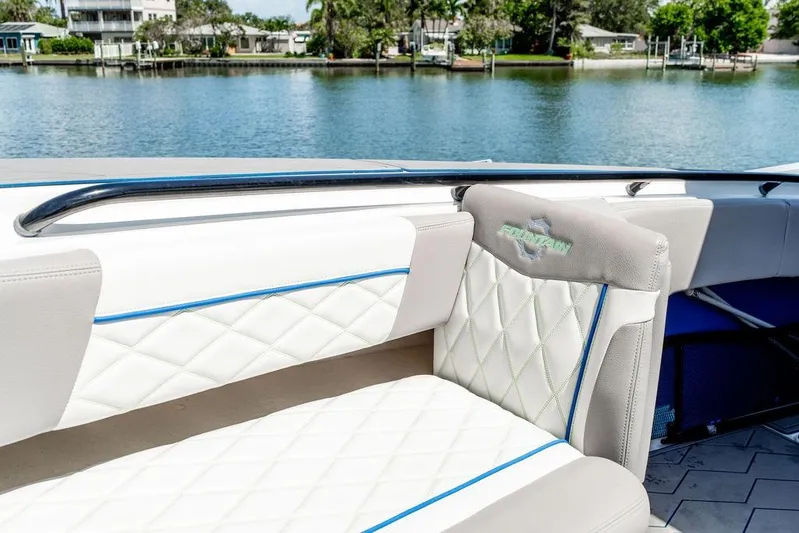  Yacht Photos Pics 2022 Fountain 34 SC boat interior with white quilted seats by the water.