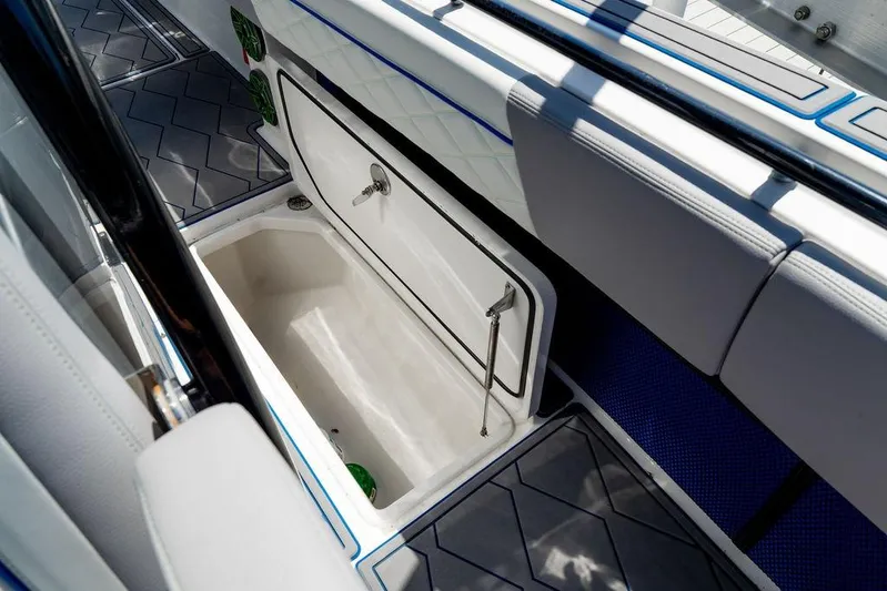  Yacht Photos Pics 2022 Fountain 34 SC boat storage compartment with open lid, showcasing interior space.