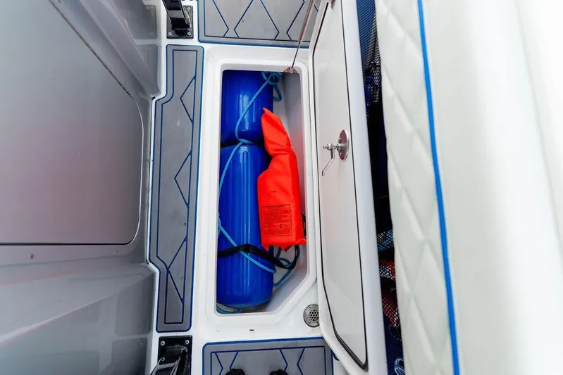  Yacht Photos Pics Storage compartment in 2022 Fountain 34 SC boat with safety equipment.