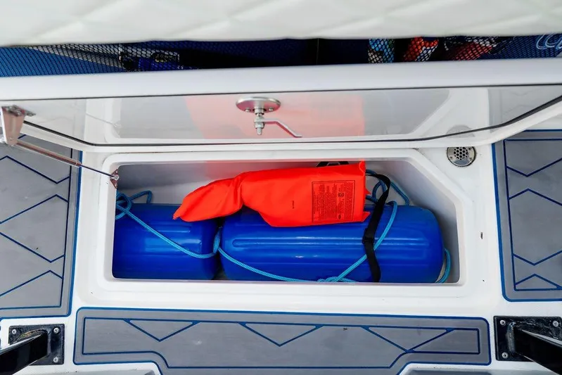  Yacht Photos Pics Storage compartment in 2022 Fountain 34 SC boat with blue fenders and orange life jacket.