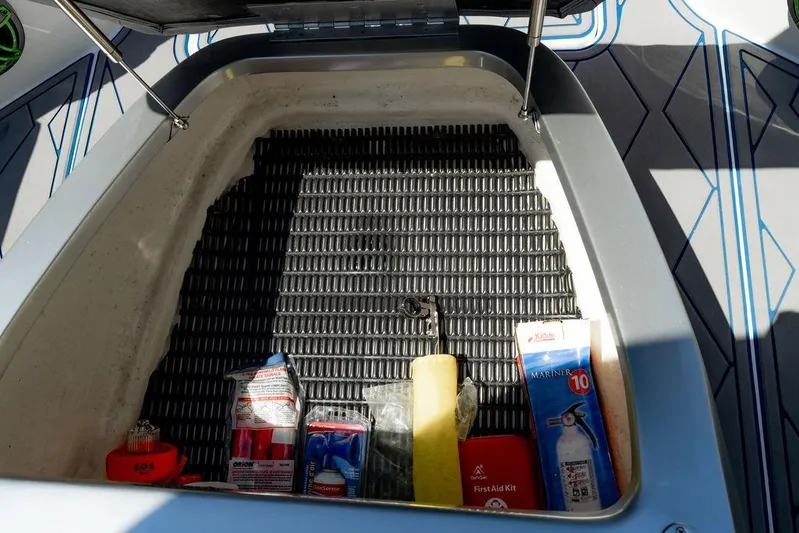  Yacht Photos Pics Storage compartment of 2022 Fountain 34 SC boat with safety equipment and supplies.
