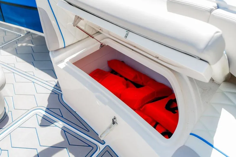  Yacht Photos Pics Storage compartment with red life jackets on a 2022 Fountain 34 SC boat.