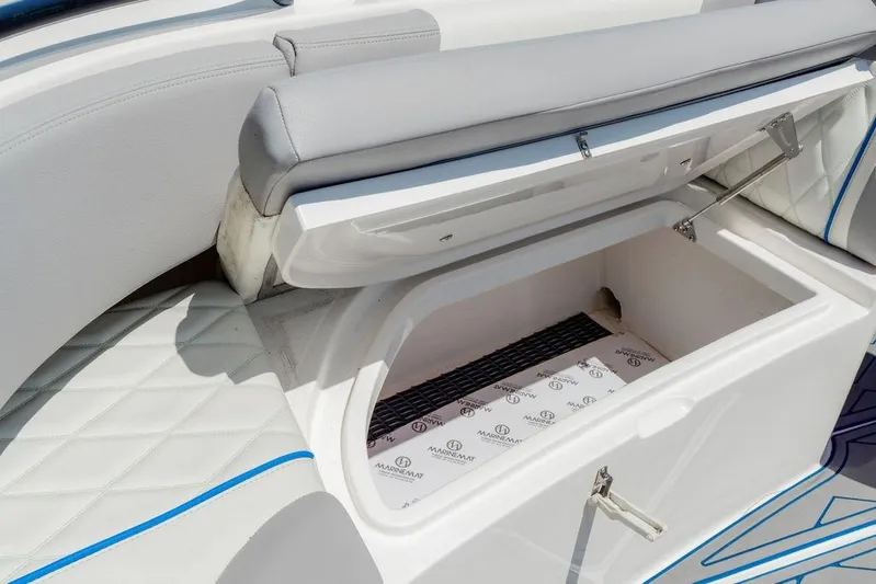  Yacht Photos Pics 2022 Fountain 34 SC boat storage compartment with cushioned seating and MarineMat lining.