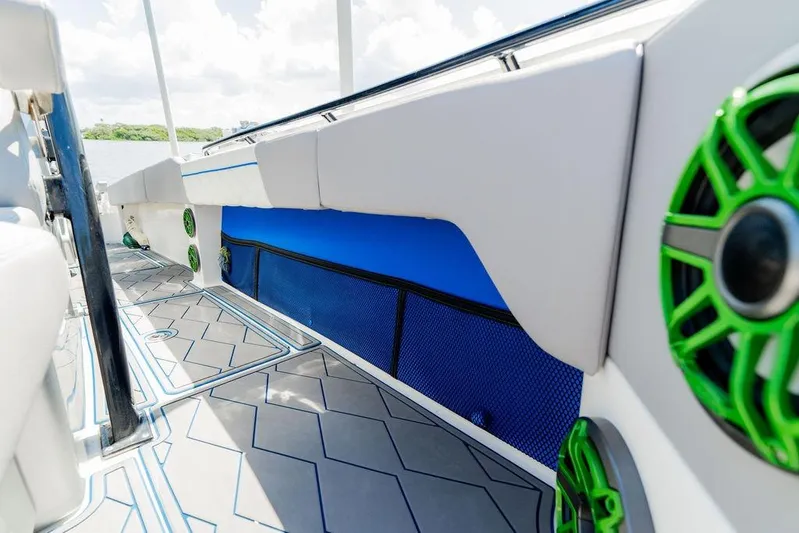  Yacht Photos Pics 2022 Fountain 34 SC boat interior with stylish seating and vibrant green speakers.