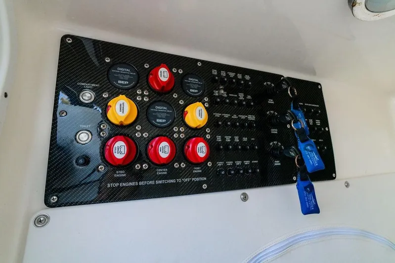  Yacht Photos Pics Control panel of 2022 Fountain 34 SC boat with switches and keychains.