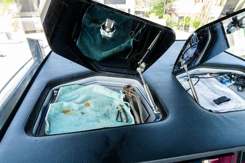  Yacht Photos Pics Open storage compartments on 2022 Fountain 34 SC boat with tools and documents.