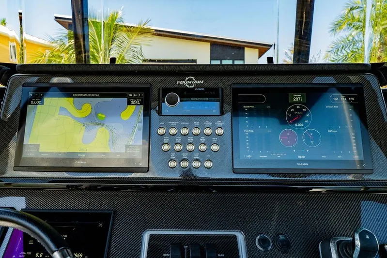  Yacht Photos Pics 2022 Fountain 34 SC boat dashboard with dual Garmin displays and control panel.