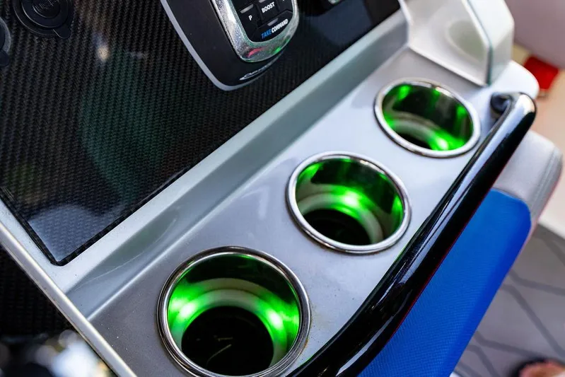  Yacht Photos Pics 2022 Fountain 34 SC boat console with illuminated cup holders and carbon fiber panel.