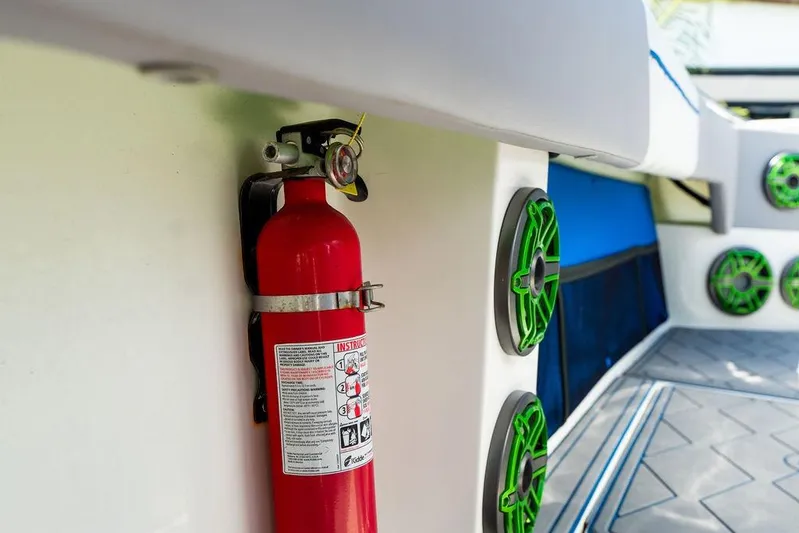  Yacht Photos Pics Fire extinguisher on 2022 Fountain 34 SC boat with green speakers in background.