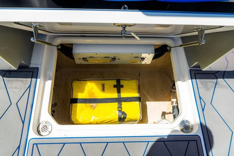  Yacht Photos Pics 2022 Fountain 34 SC storage compartment with yellow safety equipment inside.