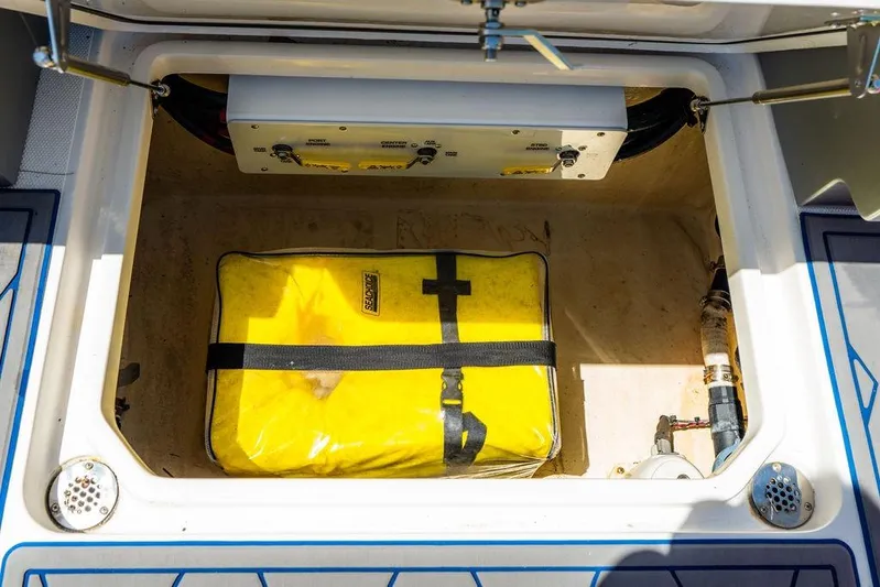  Yacht Photos Pics Open storage compartment in 2022 Fountain 34 SC boat with yellow bag and equipment.