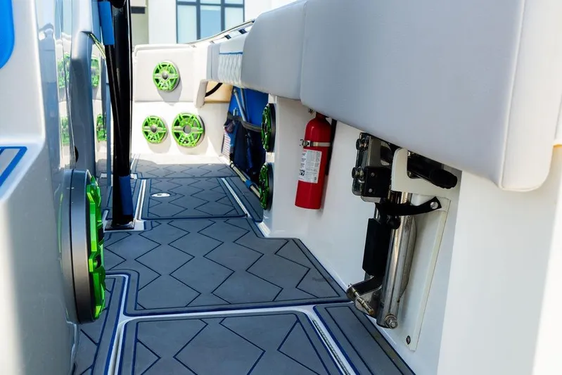  Yacht Photos Pics 2022 Fountain 34 SC boat interior with green speakers and fire extinguisher.