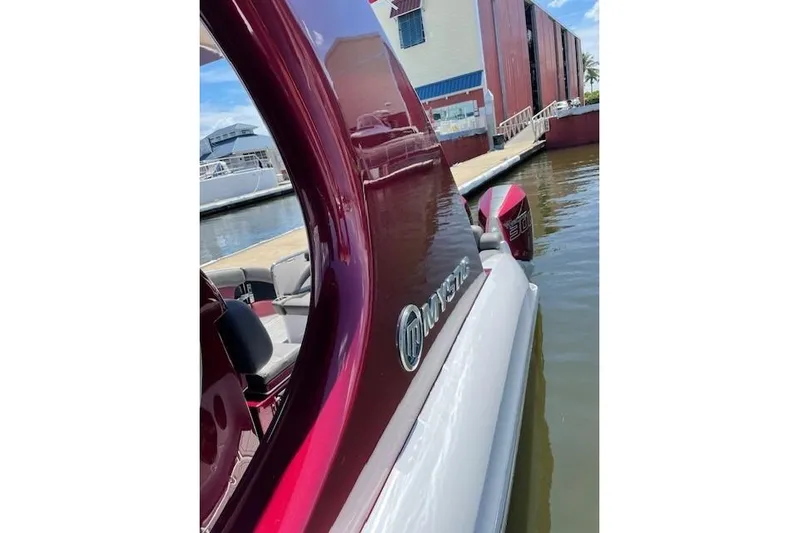  Yacht Photos Pics 2021 Mystic Powerboats M3800 docked, showcasing sleek design and vibrant color.