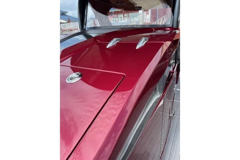  Yacht Photos Pics 2021 Mystic Powerboats M3800, sleek red deck with chrome accents.
