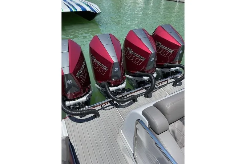 Yacht Photos Pics Four powerful outboard engines on a 2021 Mystic Powerboats M3800, docked on green water.