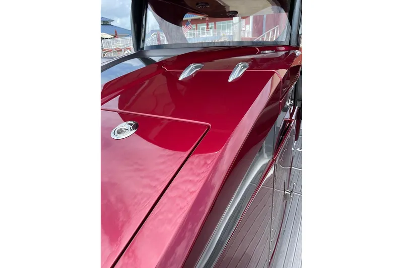  Yacht Photos Pics 2021 Mystic Powerboats M3800, sleek red exterior with chrome accents, docked at marina.