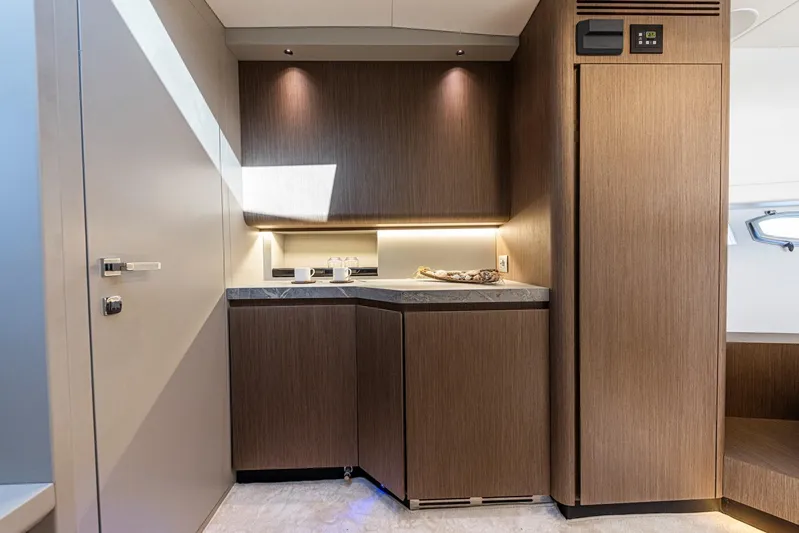  Yacht Photos Pics Luxurious interior of 2025 Rio Yachts Le Mans 45, featuring modern wood cabinetry and ambient lighting.
