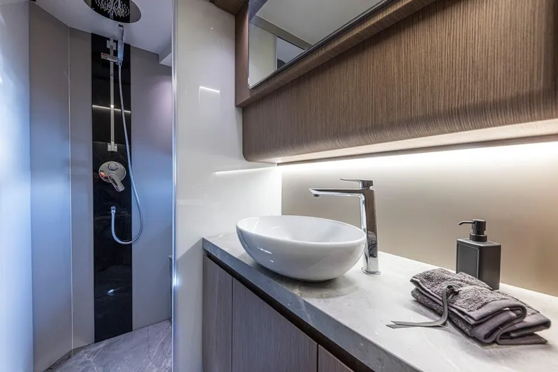  Yacht Photos Pics Luxurious bathroom in 2025 Rio Yachts Le Mans 45, featuring modern sink and shower.