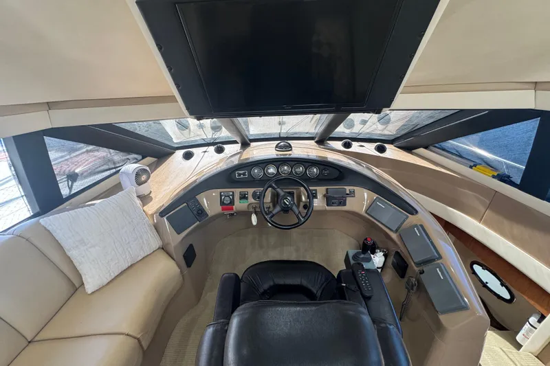 Once Around II Yacht Photos Pics 1998 Carver 530 Voyager Pilothouse helm with leather seating and modern controls.