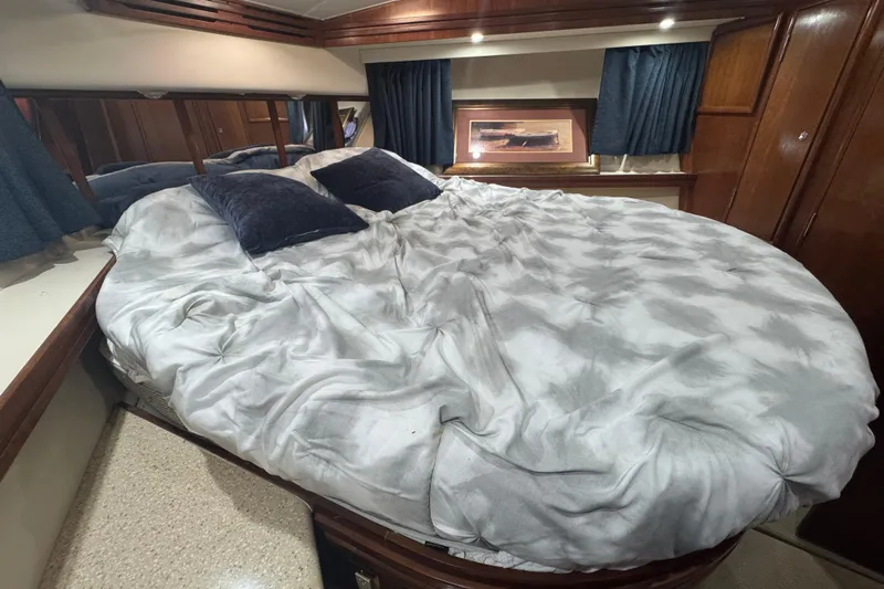 Once Around II Yacht Photos Pics Luxurious bedroom interior of 1998 Carver 530 Voyager Pilothouse yacht with plush bedding.