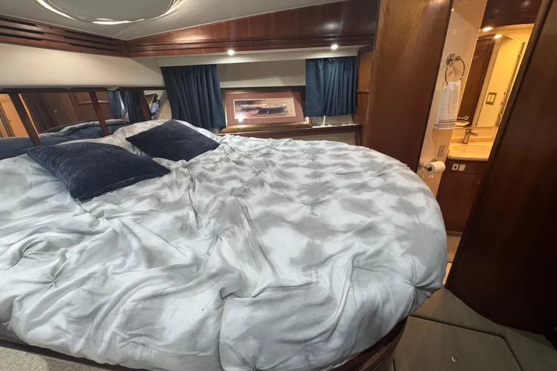 Once Around II Yacht Photos Pics Luxurious bedroom interior of 1998 Carver 530 Voyager Pilothouse yacht with plush bedding.