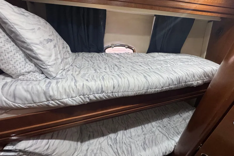 Once Around II Yacht Photos Pics 1998 Carver 530 Voyager Pilothouse interior with cozy bunk beds and elegant wood finish.