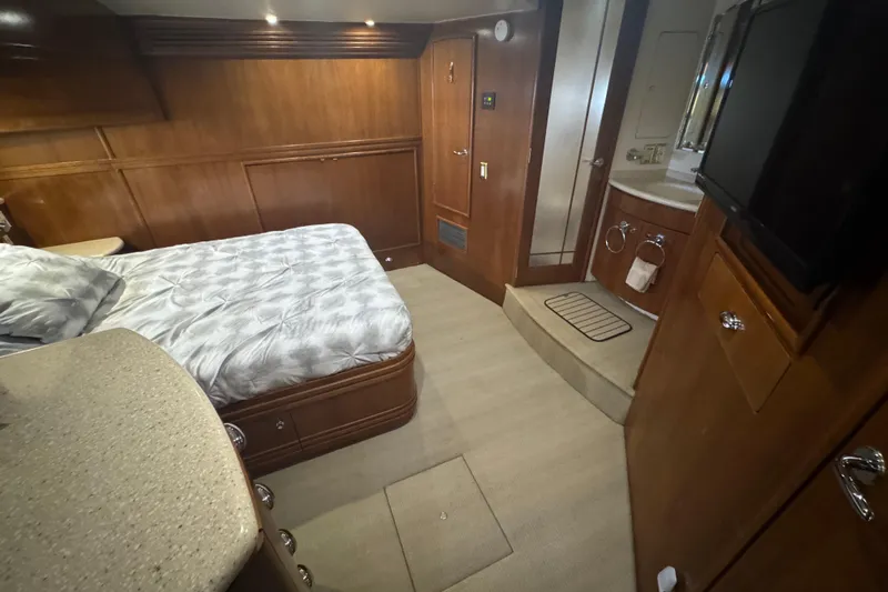 Once Around II Yacht Photos Pics Interior of 1998 Carver 530 Voyager Pilothouse with bed, wood paneling, and bathroom.
