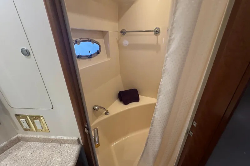 Once Around II Yacht Photos Pics Shower area in 1998 Carver 530 Voyager Pilothouse with porthole and curtain.