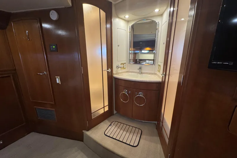 Once Around II Yacht Photos Pics Luxurious 1998 Carver 530 Voyager Pilothouse bathroom with wood accents and modern fixtures.