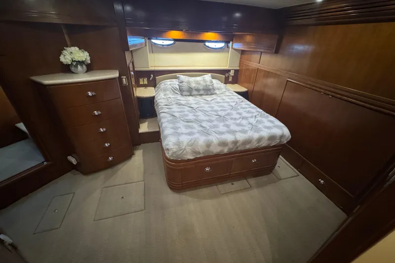Once Around II Yacht Photos Pics Luxurious bedroom interior of 1998 Carver 530 Voyager Pilothouse yacht with wood paneling.