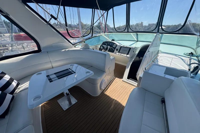 Once Around II Yacht Photos Pics 1998 Carver 530 Voyager Pilothouse interior with helm, seating, and table on teak flooring.