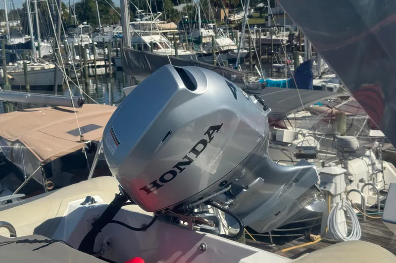 Once Around II Yacht Photos Pics Silver Honda outboard motor on a 1998 Carver 530 Voyager Pilothouse, docked at a marina.