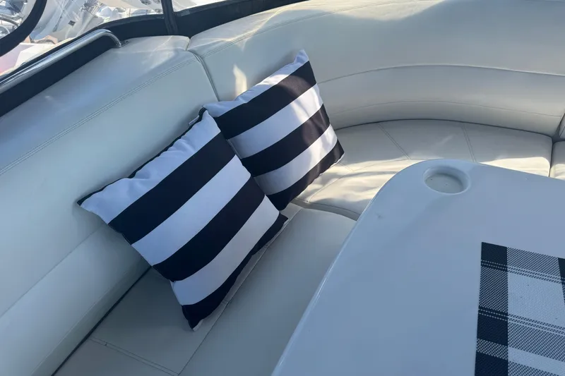 Once Around II Yacht Photos Pics Interior of 1998 Carver 530 Voyager Pilothouse with striped pillows and white seating.