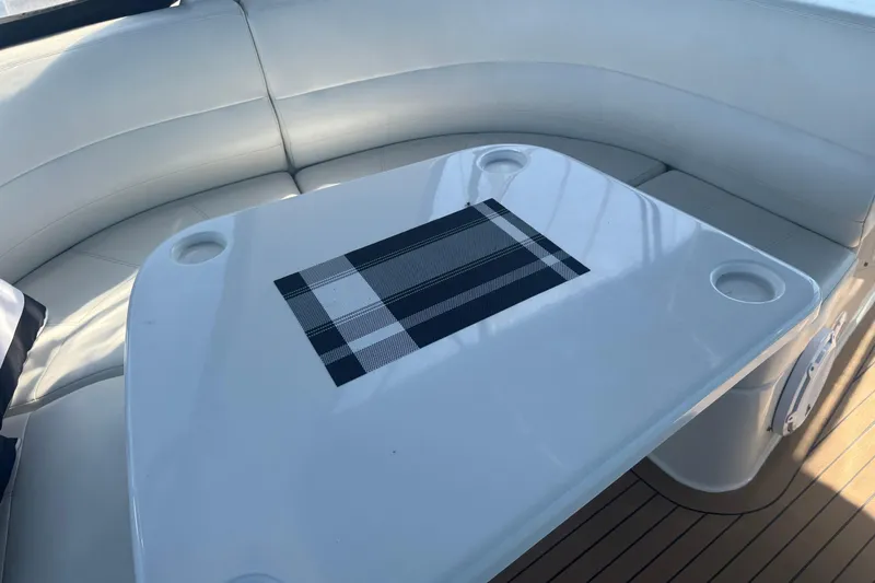 Once Around II Yacht Photos Pics Interior seating area of 1998 Carver 530 Voyager Pilothouse with a sleek table.