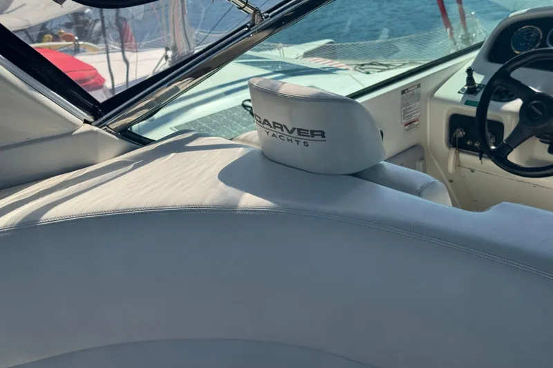 Once Around II Yacht Photos Pics Interior of 1998 Carver 530 Voyager Pilothouse yacht with steering wheel and branded seat.