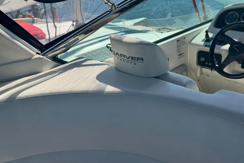 Once Around II Yacht Photos Pics 1998 Carver 530 Voyager Pilothouse interior with steering wheel and branded seat.