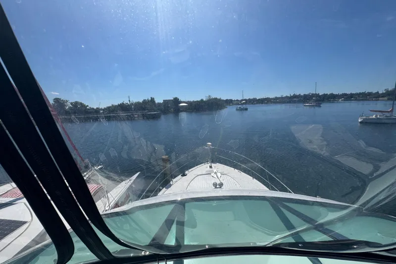 Once Around II Yacht Photos Pics View from 1998 Carver 530 Voyager Pilothouse, overlooking calm waters and distant shoreline.
