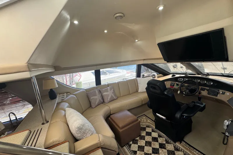 Once Around II Yacht Photos Pics Luxurious interior of 1998 Carver 530 Voyager Pilothouse with plush seating and modern helm.