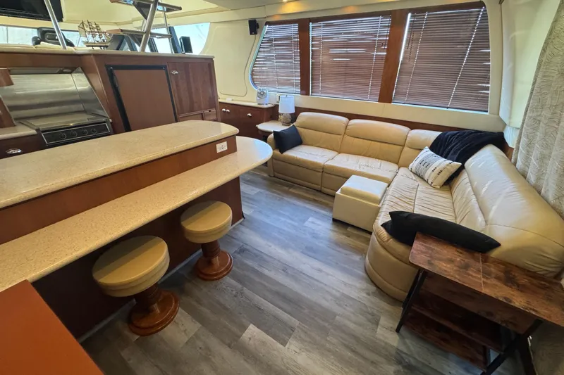 Once Around II Yacht Photos Pics Luxurious interior of 1998 Carver 530 Voyager Pilothouse with beige seating and modern kitchen.