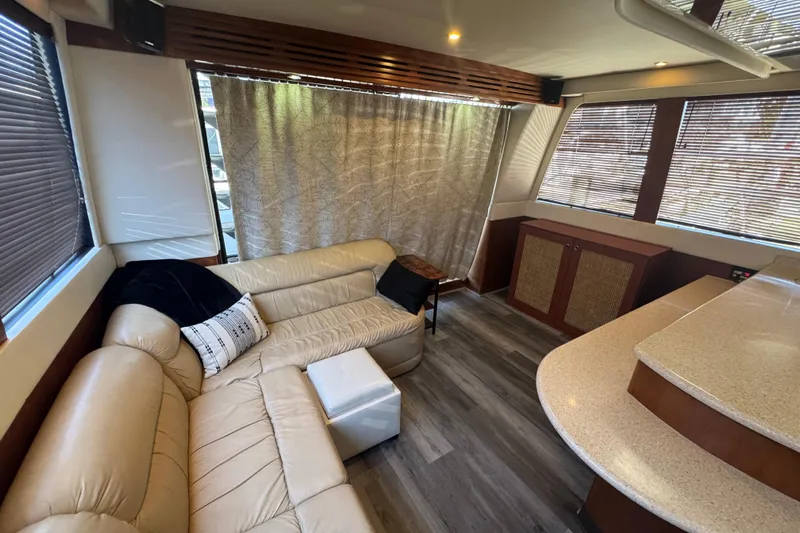 Once Around II Yacht Photos Pics Luxurious interior of 1998 Carver 530 Voyager Pilothouse with beige leather seating and wood accents.