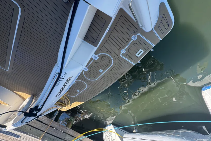 Once Around II Yacht Photos Pics 1998 Carver 530 Voyager Pilothouse docked, showcasing sleek deck design and water reflection.