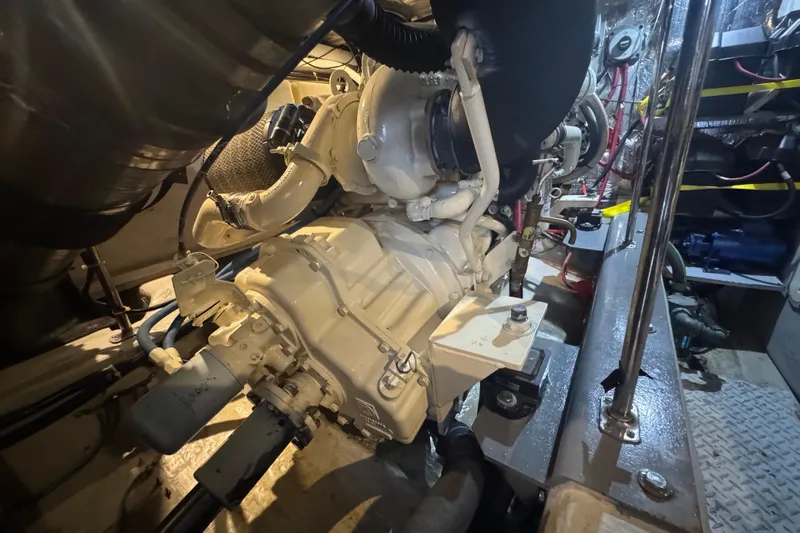 Once Around II Yacht Photos Pics Engine room of 1998 Carver 530 Voyager Pilothouse, showcasing mechanical components and piping.