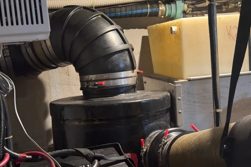 Once Around II Yacht Photos Pics Engine room of 1998 Carver 530 Voyager Pilothouse with pipes and machinery.