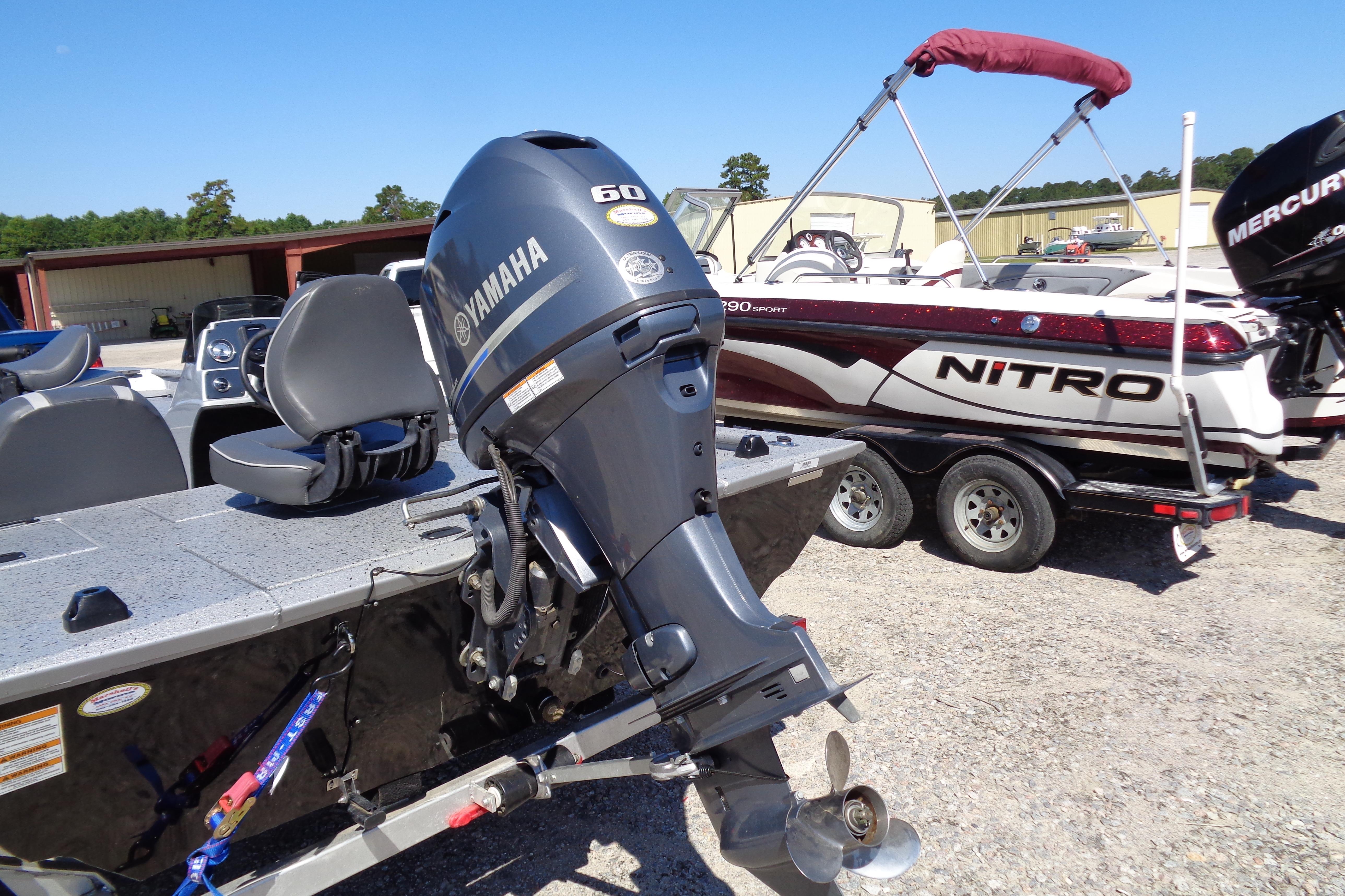 2016 Express PT175 boat with Yamaha 60 engine, parked near Nitro boat.