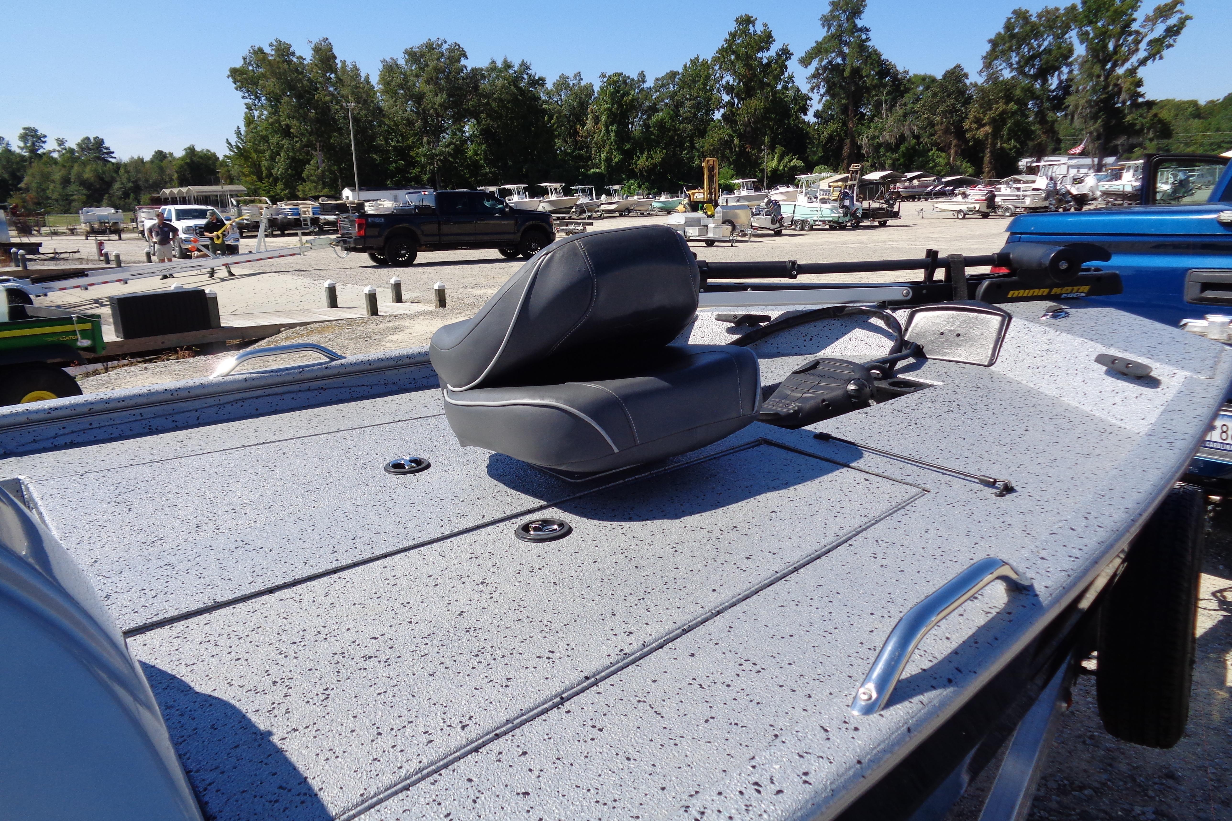 2016 Express PT175 boat with gray seating, parked outdoors in a lot.