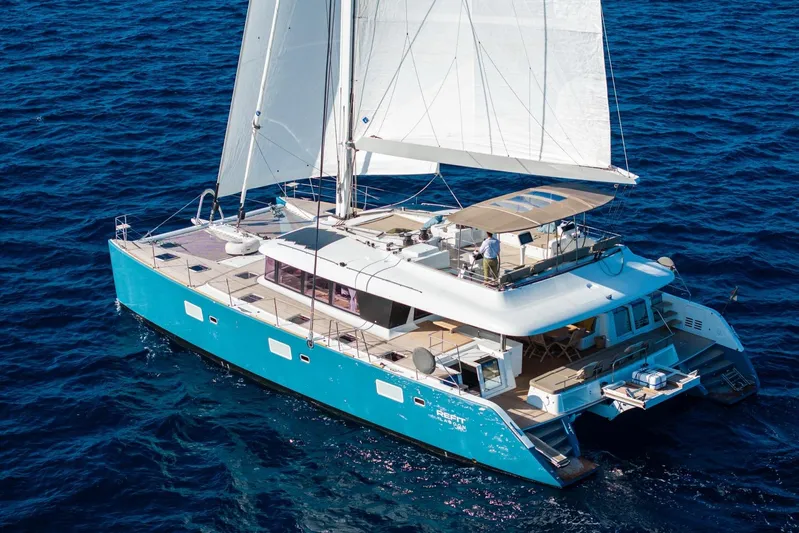  Yacht Photos Pics 2024 Lagoon 620 NEO catamaran sailing on open blue sea.