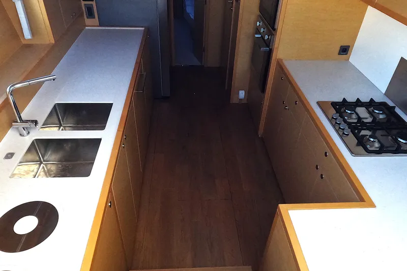  Yacht Photos Pics Modern kitchen interior of 2024 Lagoon 620 NEO yacht with sleek countertops and appliances.