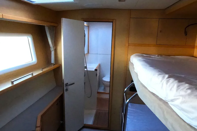  Yacht Photos Pics 2024 Lagoon 620 NEO yacht interior with bunk beds and ensuite bathroom.